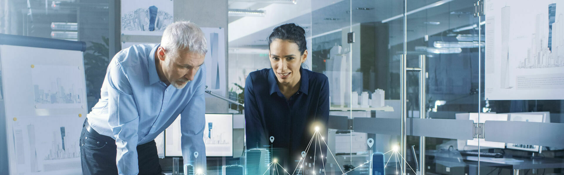Male and Female Architects Work with Holographic Augmented Reali