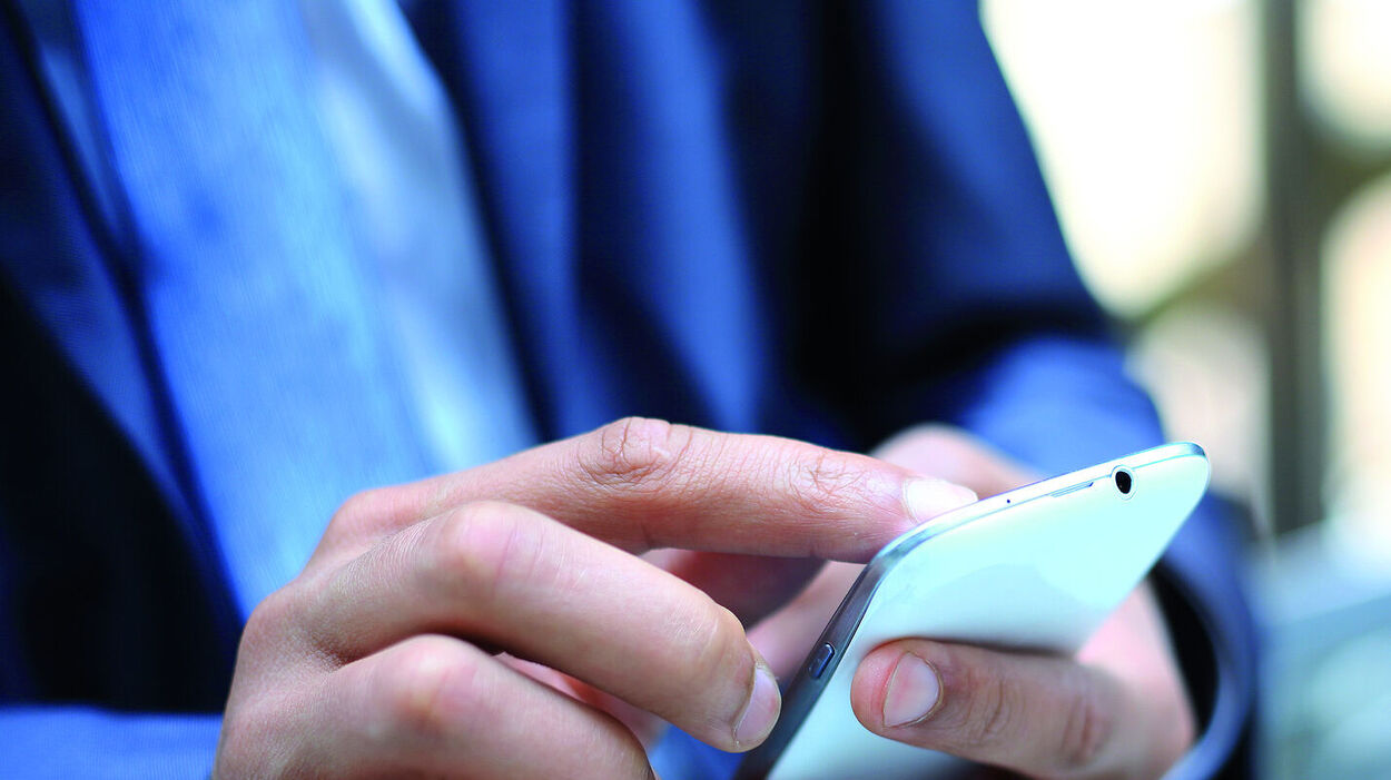 Close up of a man using mobile smart phone